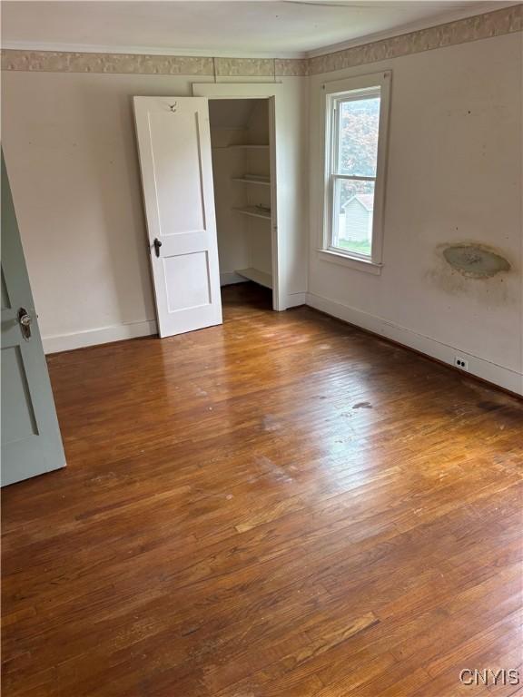 39 Standart Ave, Auburn, NY 13021 - unfurnished bedroom featuring wood finished floors, a closet, and ornamental molding