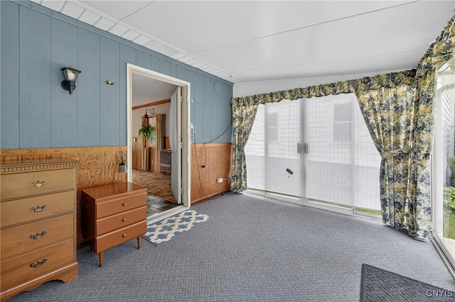7165 Manlius Center Rd, Manlius, NY 13057 - bedroom featuring carpet floors, wooden walls, and access to outside