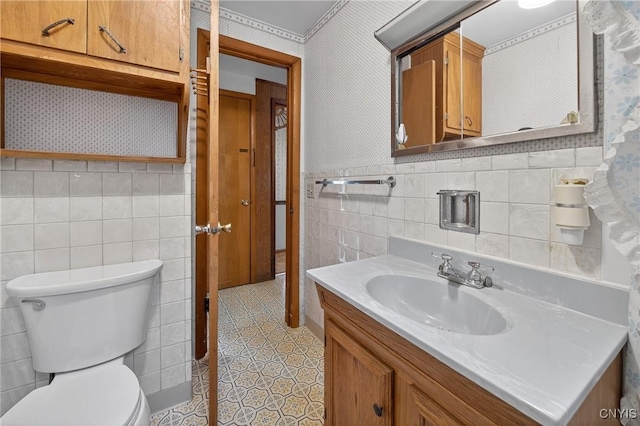 7165 Manlius Center Rd, Manlius, NY 13057 - bathroom featuring tile walls, vanity, tile patterned floors, and wainscoting