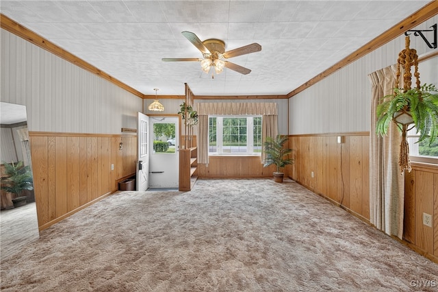 7165 Manlius Center Rd, Manlius, NY 13057 - empty room featuring carpet, ceiling fan, wooden walls, ornamental molding, and a wainscoted wall