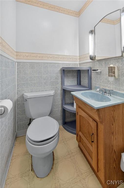 7165 Manlius Center Rd, Manlius, NY 13057 - bathroom with tile walls, vanity, wainscoting, and tile patterned floors