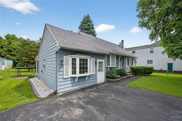 7165 Manlius Center Rd, Manlius, NY 13057 - view of front of home with a front yard and a shingled roof