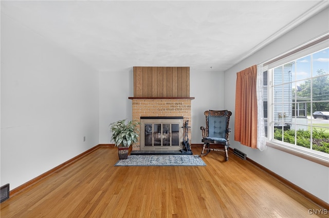 7165 Manlius Center Rd, Manlius, NY 13057 - living area featuring light wood-type flooring and a fireplace
