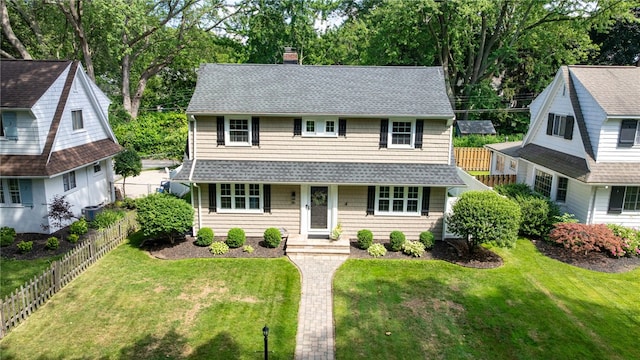 36 Dover Park, Brighton, NY 14610 - view of front of home with a chimney, roof with shingles, a fenced backyard, and view of wooded area