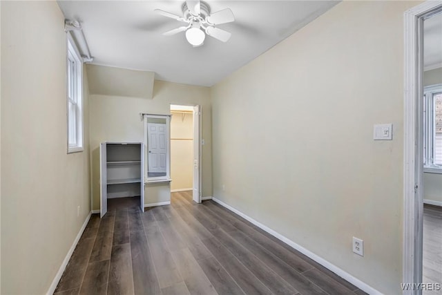 386 Davey St, Buffalo, NY 14206 - unfurnished bedroom with dark wood-type flooring, a spacious closet, and a ceiling fan