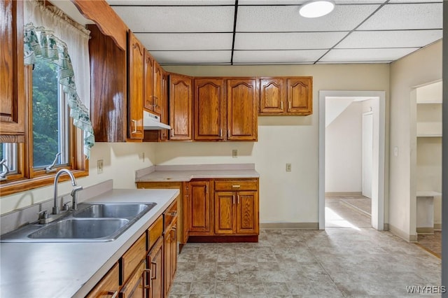 386 Davey St, Buffalo, NY 14206 - kitchen featuring brown cabinetry, a drop ceiling, light countertops, and extractor fan