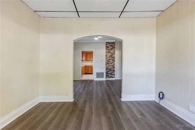 386 Davey St, Buffalo, NY 14206 - empty room featuring arched walkways, dark wood-type flooring, and a paneled ceiling