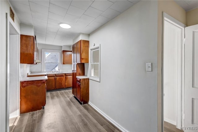 386 Davey St, Buffalo, NY 14206 - kitchen with brown cabinetry, light countertops, and wood finished floors