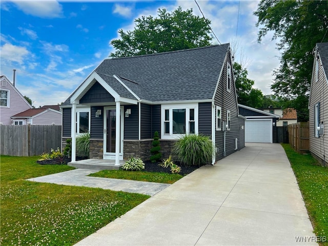 155 Barnsdale Ave, West Seneca, NY 14224 - view of front of house with stone siding, a shingled roof, a detached garage, and an outdoor structure