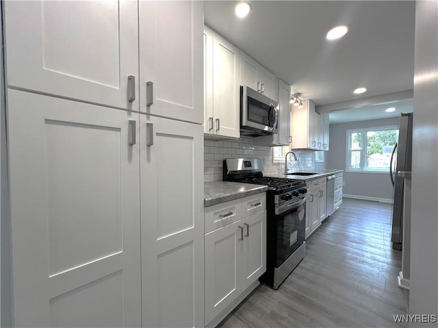 155 Barnsdale Ave, West Seneca, NY 14224 - kitchen featuring appliances with stainless steel finishes, recessed lighting, white cabinets, tasteful backsplash, and light wood-style floors