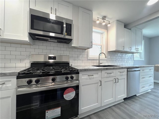 155 Barnsdale Ave, West Seneca, NY 14224 - kitchen featuring appliances with stainless steel finishes, white cabinetry, light wood-type flooring, and light stone counters