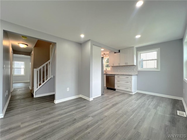 155 Barnsdale Ave, West Seneca, NY 14224 - unfurnished living room featuring wood finished floors, stairs, and recessed lighting