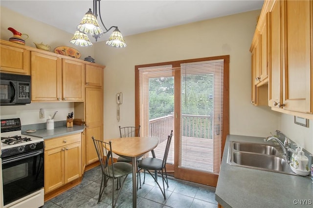 315 Boyden St, Syracuse, NY 13203 - kitchen with white gas stove, black microwave, light brown cabinets, and hanging light fixtures
