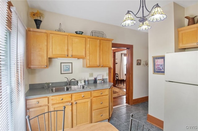 315 Boyden St, Syracuse, NY 13203 - kitchen with freestanding refrigerator, dark tile patterned flooring, light brown cabinets, a chandelier, and decorative light fixtures