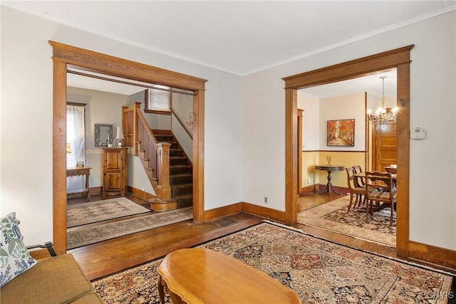 315 Boyden St, Syracuse, NY 13203 - foyer with wood finished floors, stairway, a chandelier, and crown molding