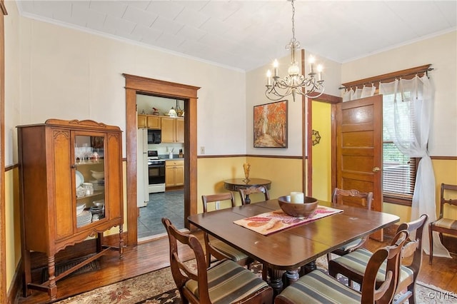 315 Boyden St, Syracuse, NY 13203 - dining area with dark wood-style floors, a chandelier, and ornamental molding