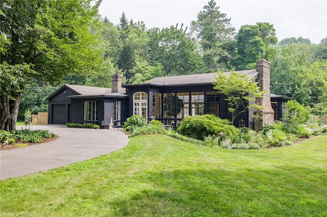 3399 Elmwood Ave, Brighton, NY 14610 - view of front of property featuring a chimney, a front lawn, driveway, and an attached garage