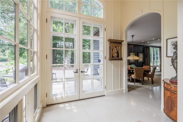 3399 Elmwood Ave, Brighton, NY 14610 - doorway with french doors, arched walkways, a high ceiling, and a decorative wall
