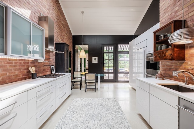 3399 Elmwood Ave, Brighton, NY 14610 - kitchen with modern cabinets, lofted ceiling, wall chimney exhaust hood, light countertops, and white cabinets