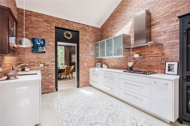 3399 Elmwood Ave, Brighton, NY 14610 - kitchen featuring lofted ceiling, modern cabinets, wall chimney exhaust hood, glass insert cabinets, and light countertops