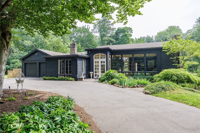 3399 Elmwood Ave, Brighton, NY 14610 - ranch-style house featuring a chimney, driveway, an attached garage, and a shingled roof
