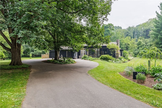 3399 Elmwood Ave, Brighton, NY 14610 - view of front of house with asphalt driveway and a front lawn