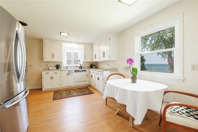 760 Beach Ave, Rochester, NY 14612 - kitchen featuring freestanding refrigerator, plenty of natural light, light countertops, and light wood-style flooring