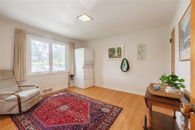 760 Beach Ave, Rochester, NY 14612 - living area with stacked washer / drying machine, light wood-style floors, and ornamental molding