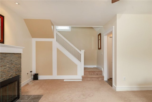 121 Reynolds Ave, Corning City, NY 14830 - unfurnished living room featuring carpet flooring, a fireplace, and stairs