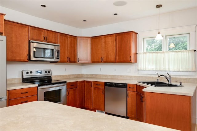 121 Reynolds Ave, Corning City, NY 14830 - kitchen featuring appliances with stainless steel finishes, brown cabinetry, and light countertops