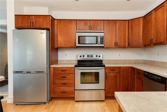 121 Reynolds Ave, Corning City, NY 14830 - kitchen featuring stainless steel appliances, light countertops, light wood finished floors, and brown cabinets