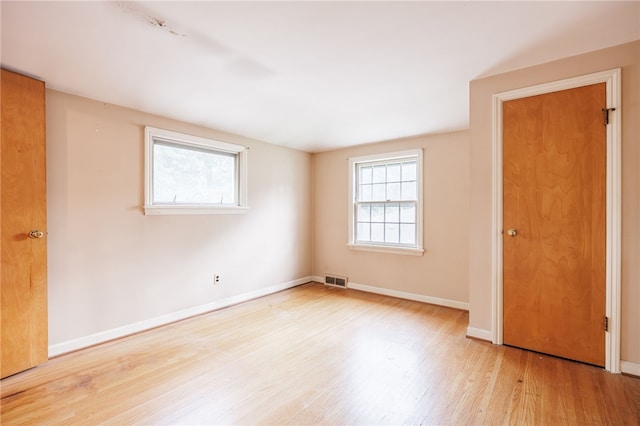 360 San Gabriel Dr, Rochester, NY 14610 - unfurnished bedroom with multiple windows and wood finished floors