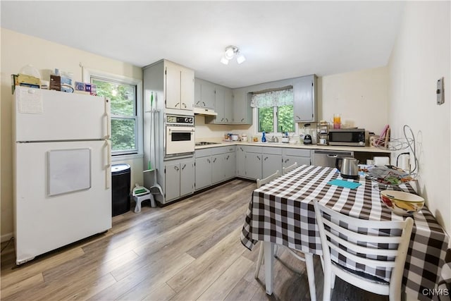 1018-20 Ackerman Ave, Syracuse, NY 13210 - kitchen featuring gray cabinets, appliances with stainless steel finishes, light wood finished floors, and light countertops