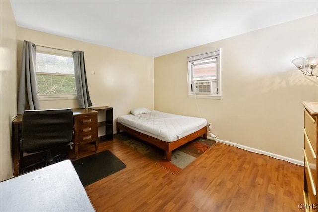 1018-20 Ackerman Ave, Syracuse, NY 13210 - bedroom with wood finished floors, multiple windows, and cooling unit