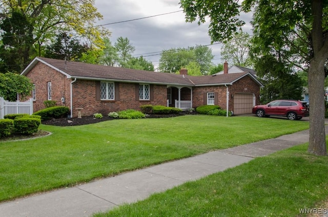 573 Locust St, North Tonawanda, NY 14120 - ranch-style home with a garage, a chimney, brick siding, and a front yard