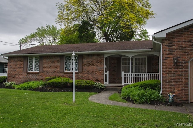 573 Locust St, North Tonawanda, NY 14120 - ranch-style home featuring a front yard, a porch, and brick siding