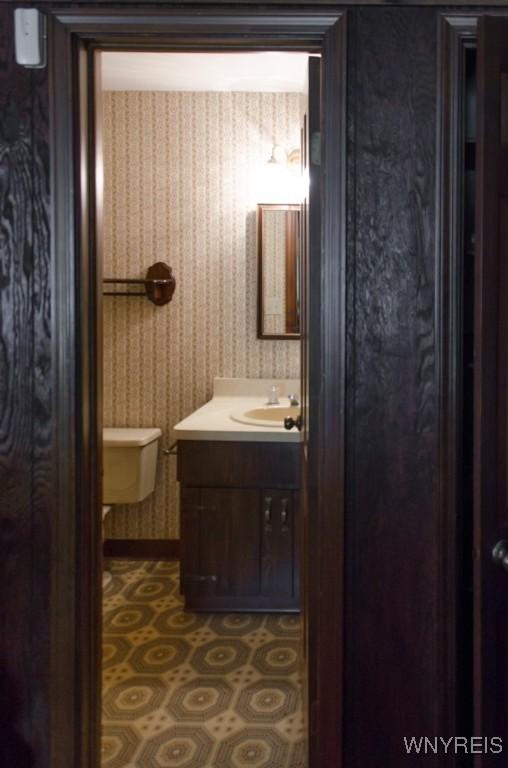 573 Locust St, North Tonawanda, NY 14120 - bathroom with wallpapered walls and vanity