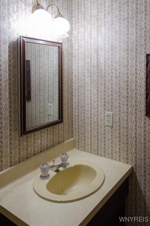 573 Locust St, North Tonawanda, NY 14120 - bathroom with wallpapered walls and vanity