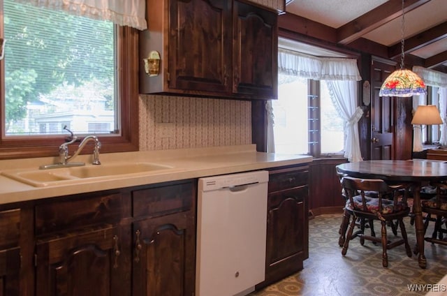 573 Locust St, North Tonawanda, NY 14120 - kitchen with dishwasher, light countertops, beamed ceiling, dark brown cabinetry, and dark floors