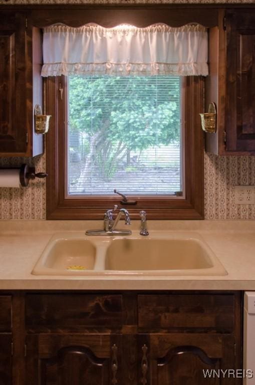 573 Locust St, North Tonawanda, NY 14120 - kitchen view of light countertops, wallpapered walls, and dark brown cabinetry