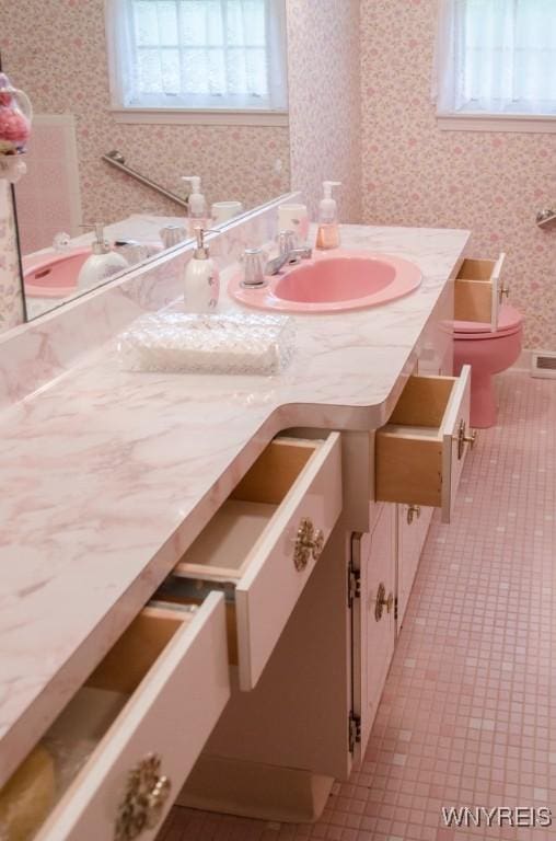 573 Locust St, North Tonawanda, NY 14120 - bathroom featuring vanity, wallpapered walls, and tile patterned flooring