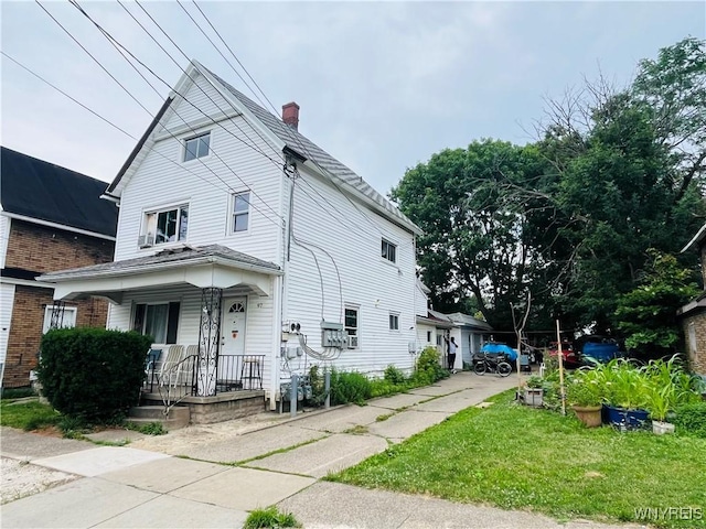 97 Kail St, Buffalo, NY 14207 - view of front of house with covered porch, a chimney, and a front yard