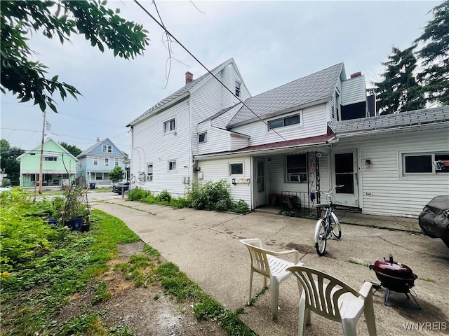 97 Kail St, Buffalo, NY 14207 - back of house featuring an outdoor fire pit, a chimney, and covered porch