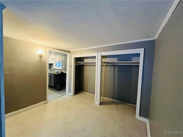 97 Kail St, Buffalo, NY 14207 - unfurnished bedroom featuring crown molding, multiple closets, light marble finish floors, and connected bathroom