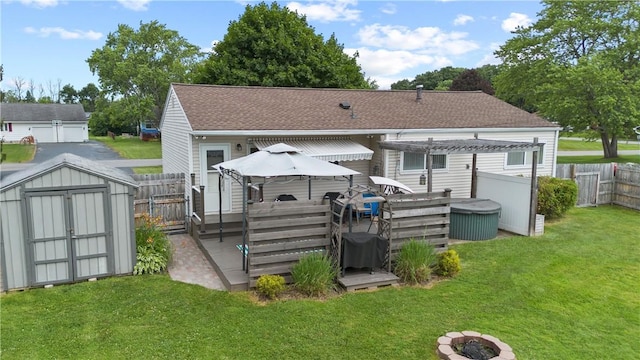 111 Crimson Bramble Rd, Henrietta, NY 14623 - rear view of property featuring a fenced backyard, roof with shingles, a storage shed, and a jacuzzi