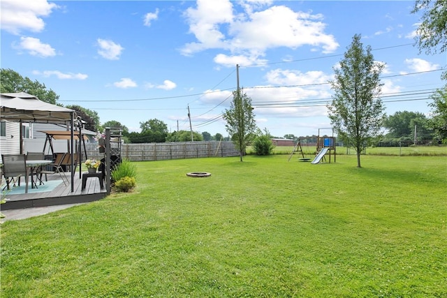 111 Crimson Bramble Rd, Henrietta, NY 14623 - fenced backyard with a gazebo, a wooden deck, an outdoor fire pit, a playground, and outdoor dining area