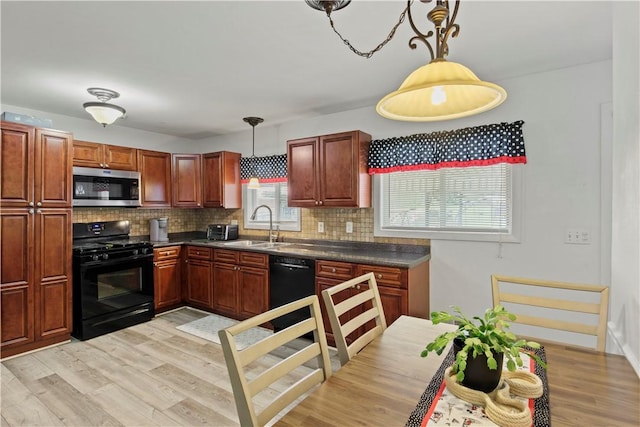 111 Crimson Bramble Rd, Henrietta, NY 14623 - kitchen with black appliances, dark countertops, tasteful backsplash, and light wood-style flooring