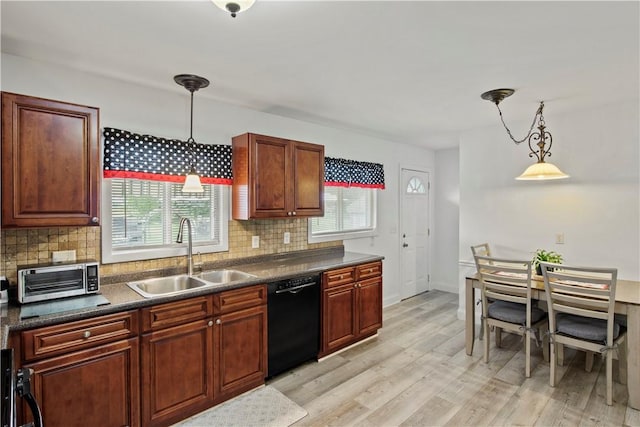 111 Crimson Bramble Rd, Henrietta, NY 14623 - kitchen with backsplash, dark countertops, black dishwasher, light wood-style flooring, and decorative light fixtures