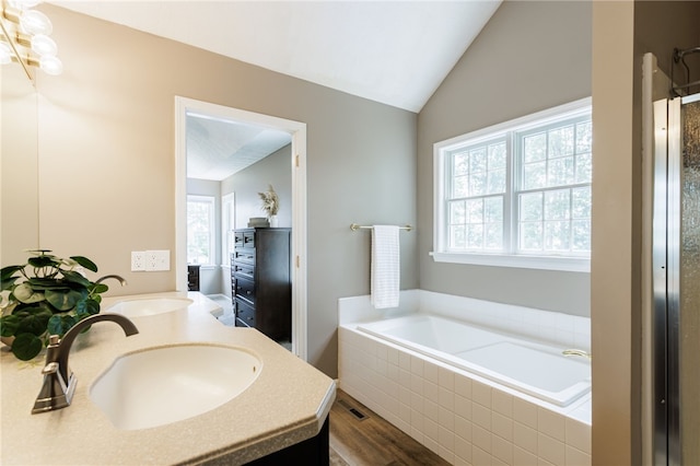 2023 Rainbow Ln, Lima, NY 14485 - bathroom with a bath, double vanity, wood finished floors, and lofted ceiling