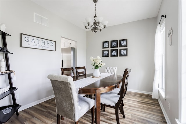 2023 Rainbow Ln, Lima, NY 14485 - dining area with a chandelier and light wood-type flooring